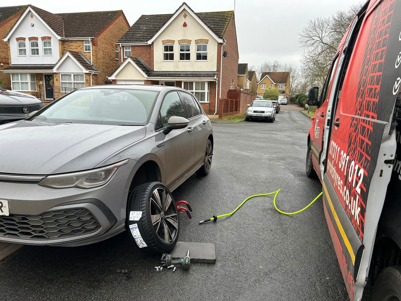 Silver SUV on the jack during a tyre change