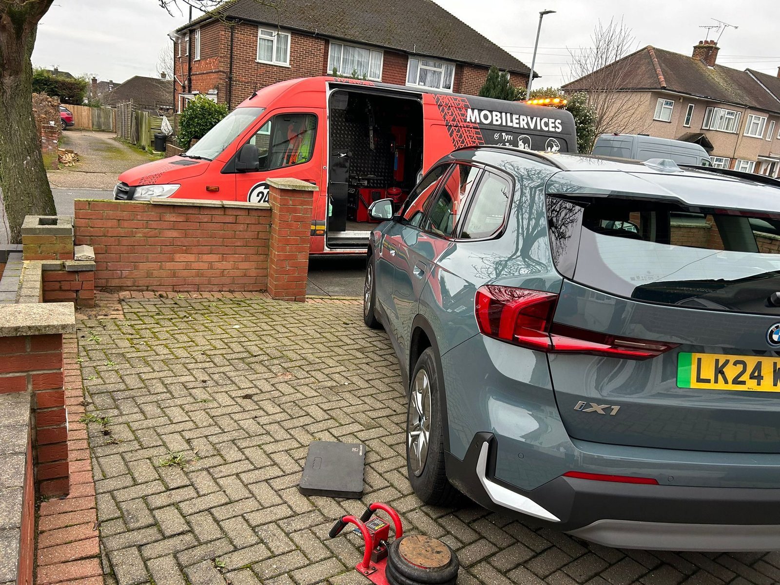 Silver SUV and the Prof's van on a driveway